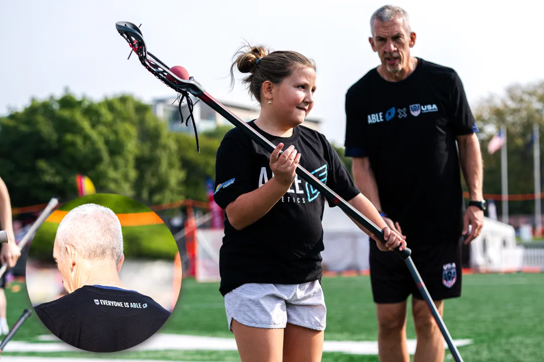 Tony Resch works with an athlete during an Able Athletics lacrosse clinic in Indianapolis as part of the USA Lacrosse Experience.