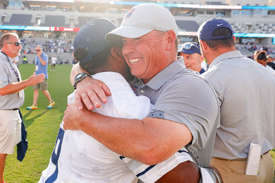 Charley Toomey hugs Trevor Baptiste after U.S. men's team wins the 2023 World Lacrosse championship.