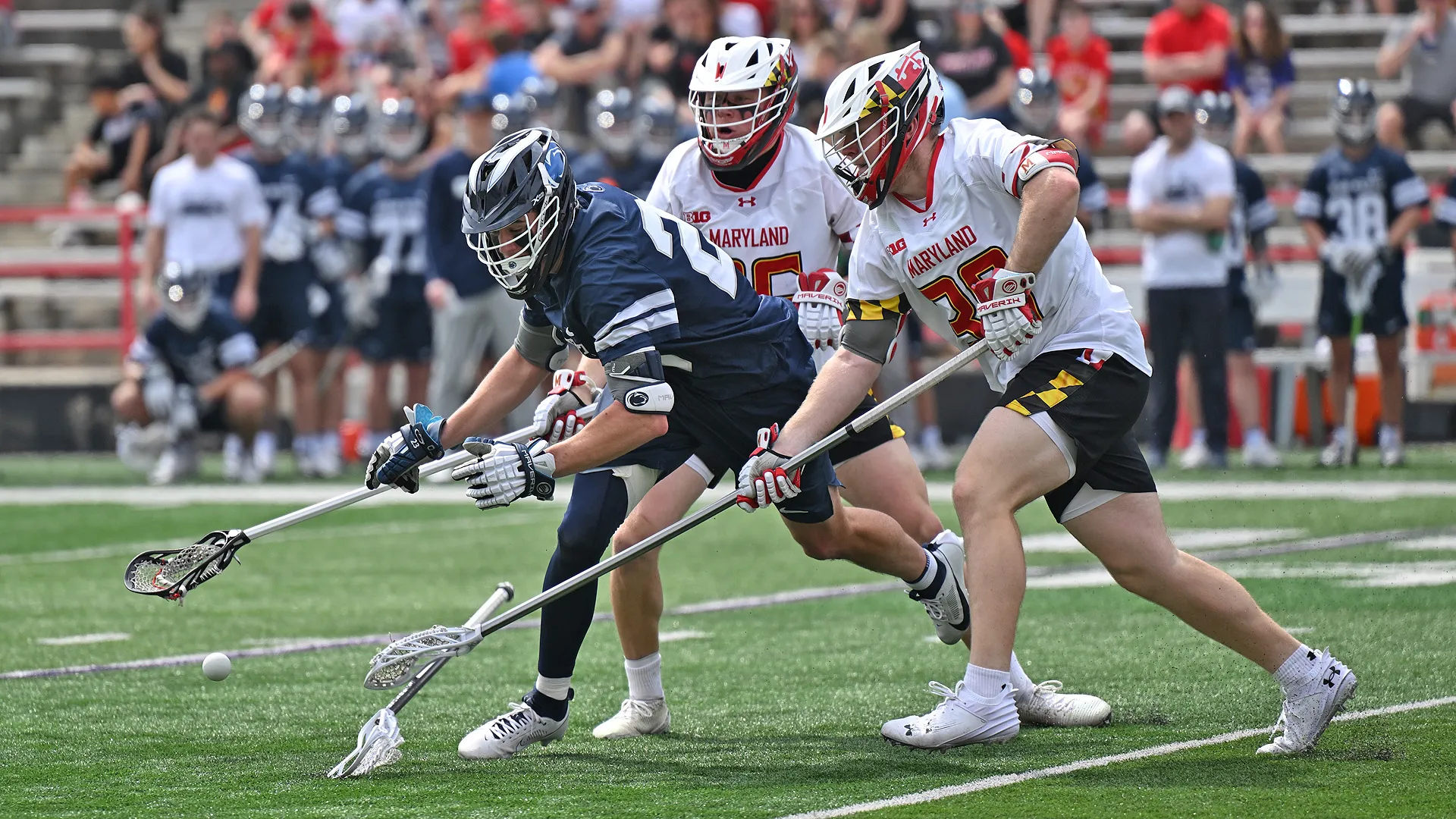 Maryland defender with check on Penn State lacrosse player.