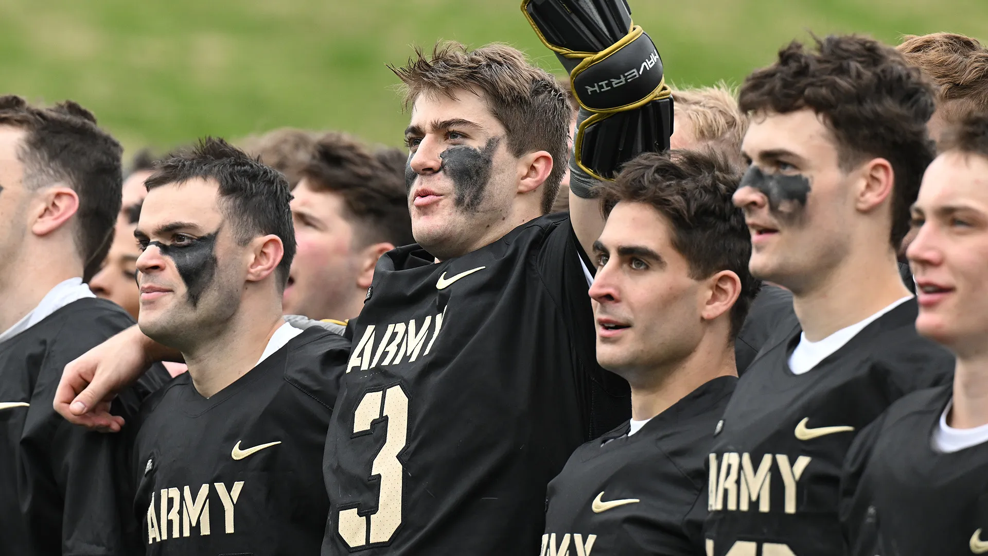 Jackson Eicher is surrounded by his teammates after scoring the game-winning goal against Navy.