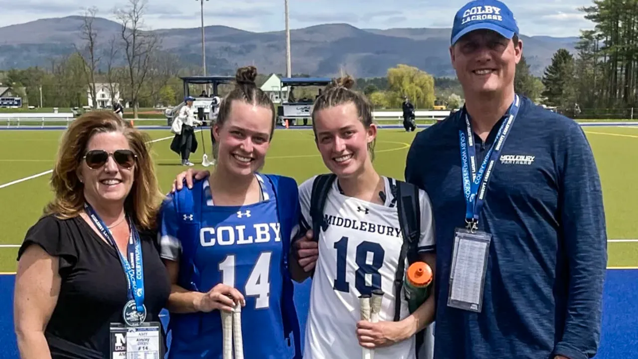 Twin sisters Ainsley (14) and Kelcey (18) Dion with their parents after a Colby-Middlebury game