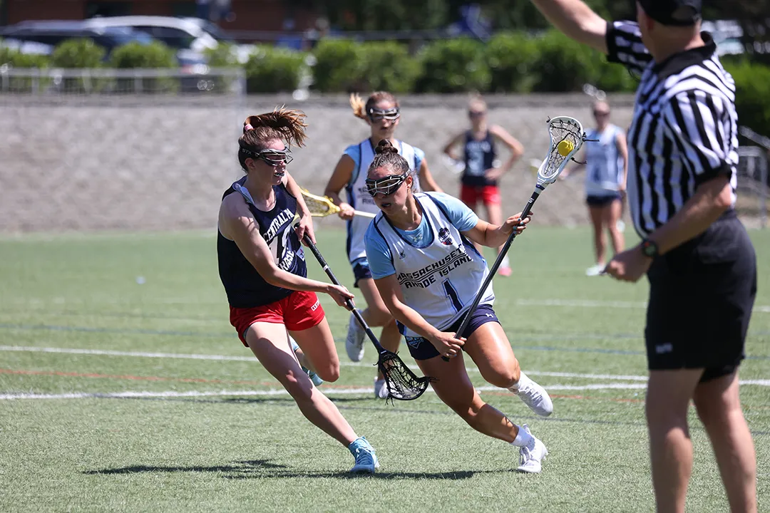 Girls lacrosse player running with the ball at USA Lacrosse National Tournament.