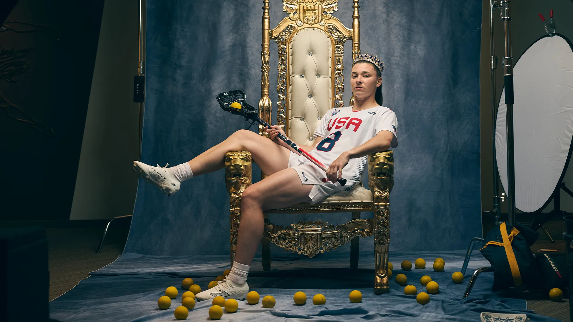 Charlotte North sits on a gold throne staged in the National Lacrosse Hall of Fame at USA Lacrosse headquarters in Sparks, Md.
