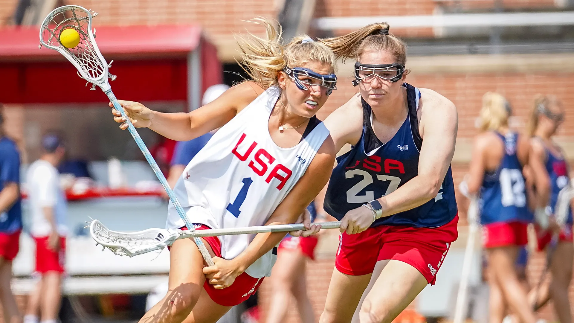Chloe Humphrey drives against Izzy Scane during a USA Lacrosse training camp