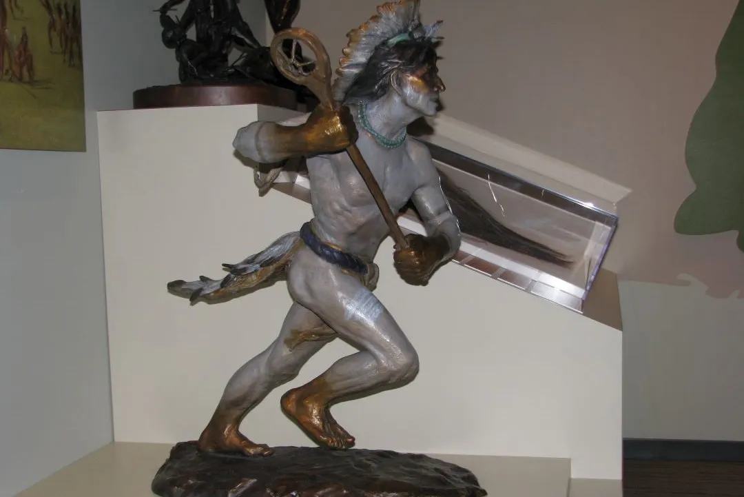 The Ball Player painted bronze sculpture