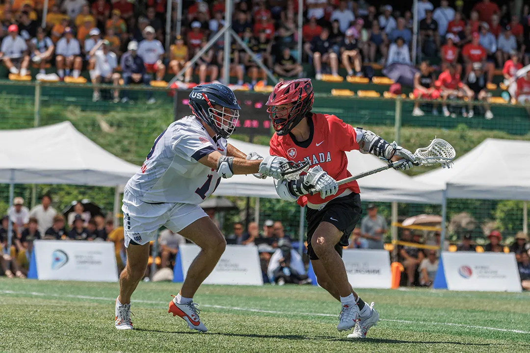 USA and Canada lacrosse players match up on the field at the world championship