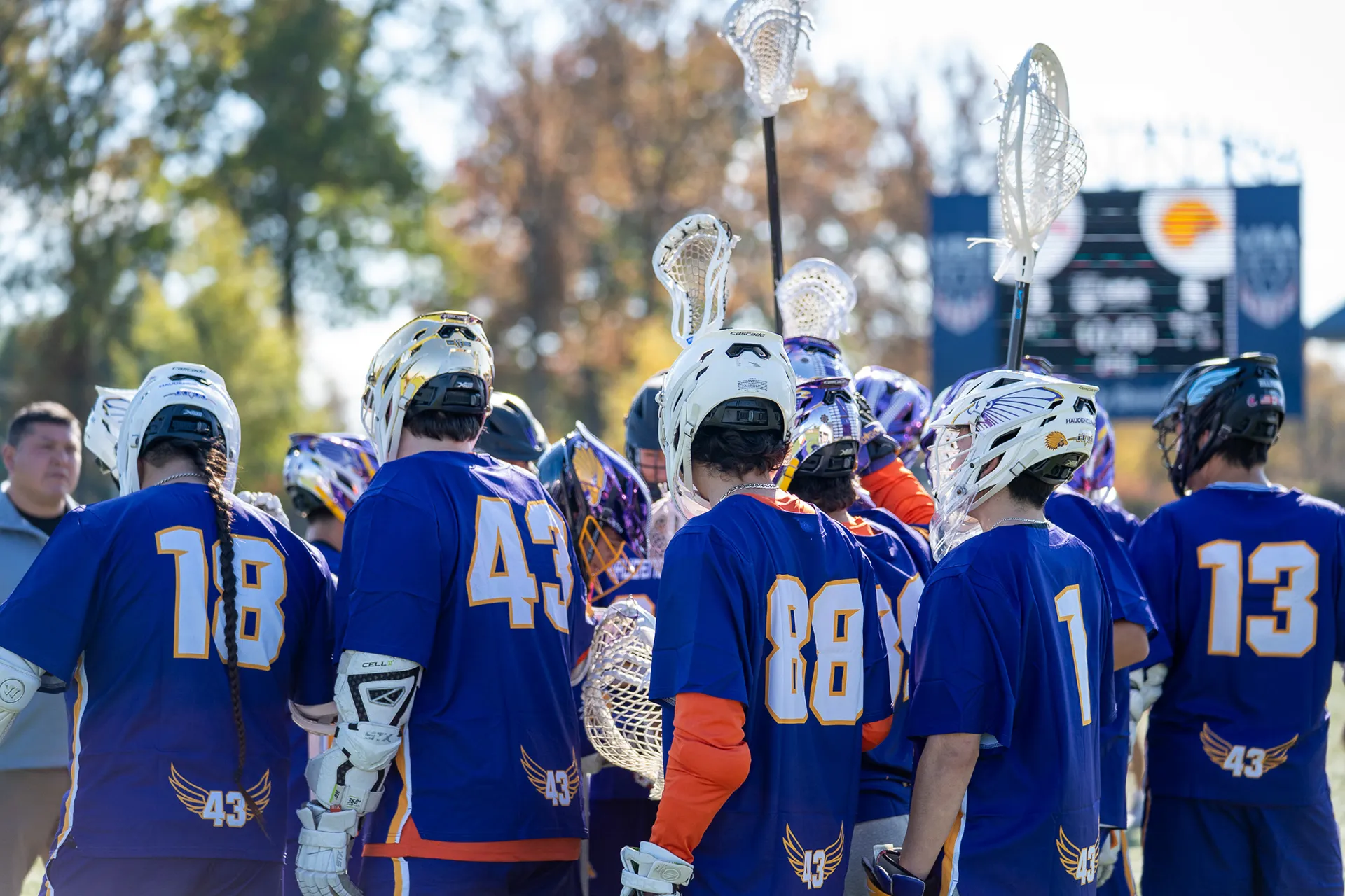 Haudenosaunee boys' lacrosse players in a huddle during the Brogden Cup