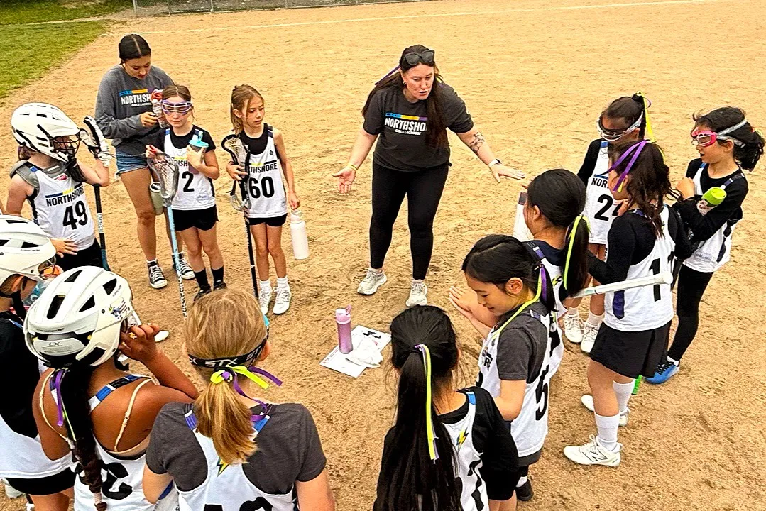 Coach Heather Tabisola speaks to her team