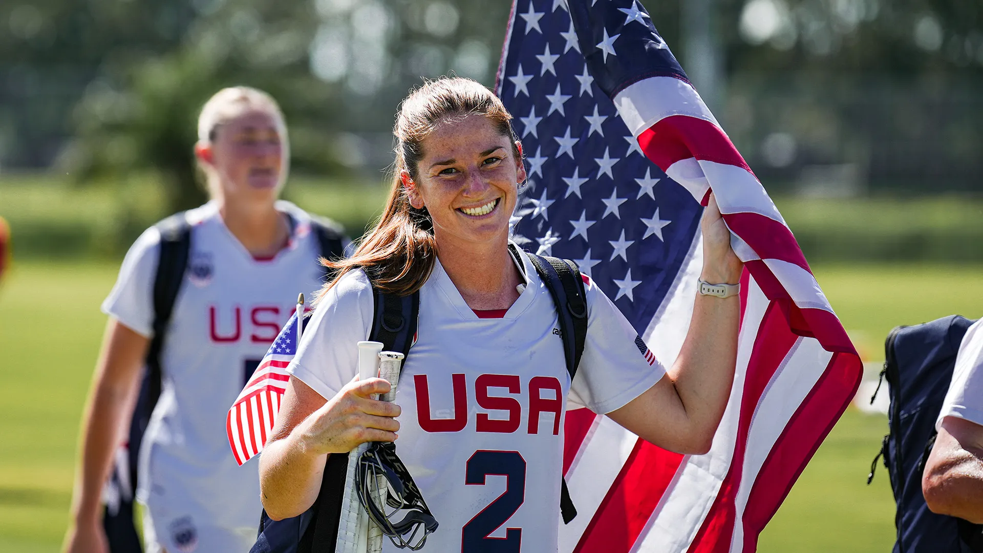 sam apuzzo carries the american flag onto the field at the 2025 PALA championship