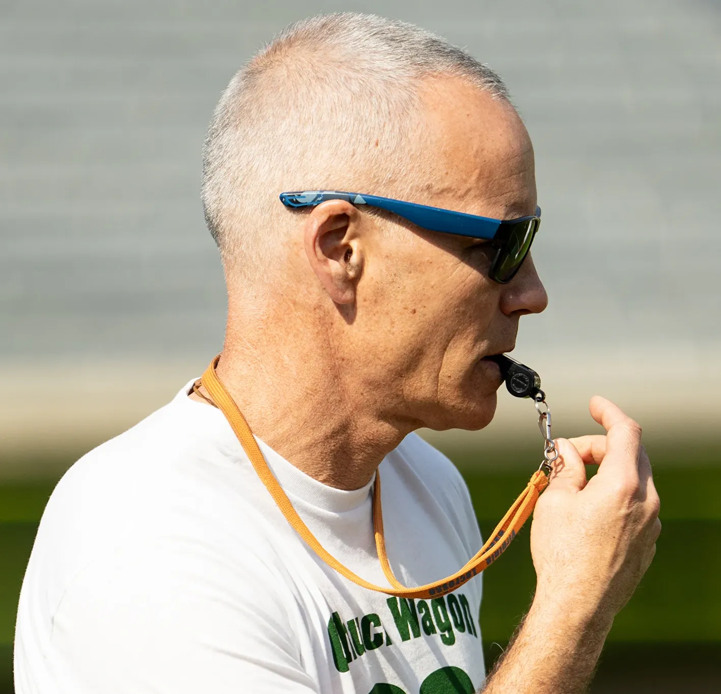Virginia men's lacrosse coach Lars Tiffany with whistle in mouth