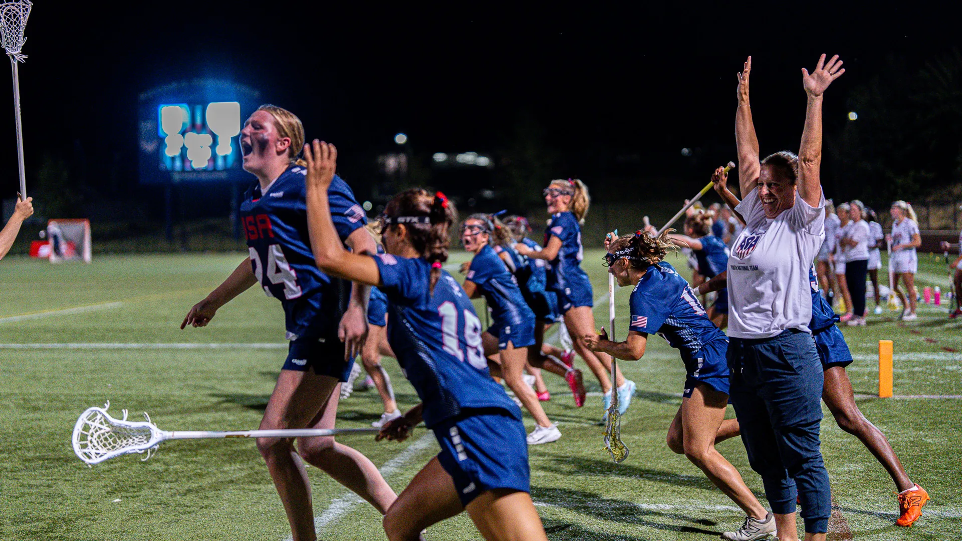 USA Lacrosse girls NTPD players jump on the sideline in celebration