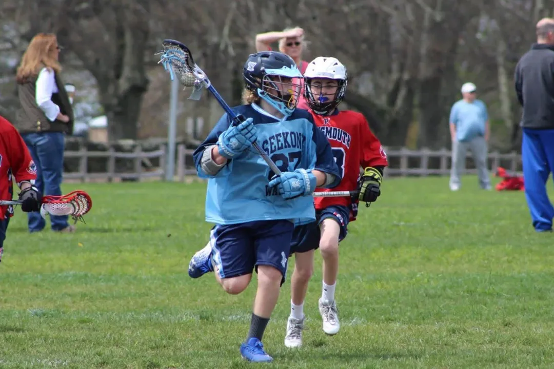 players in action from the rhode island youth lacrosse league