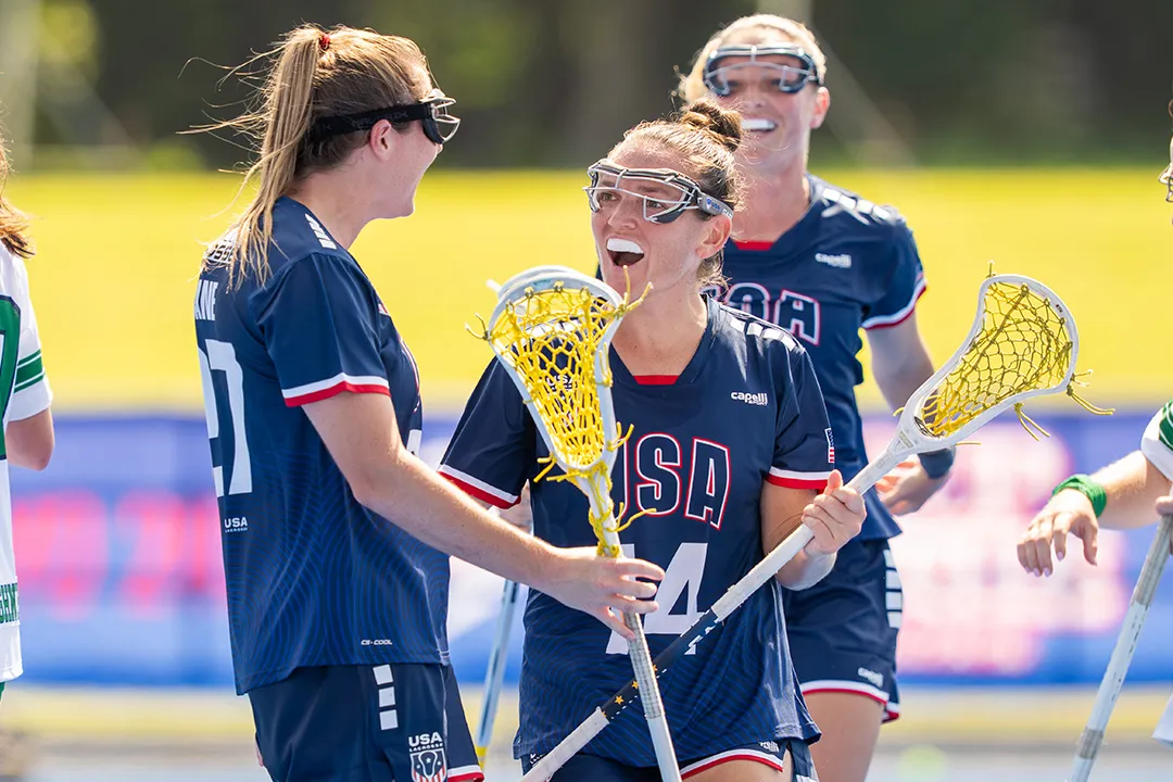 Izzy Scane (27) and Kenzie Kent (14) celebrate after a USA goal in the World Lacrosse Women's Championship opening victory over Ireland at Oi Stadium in Tokyo.