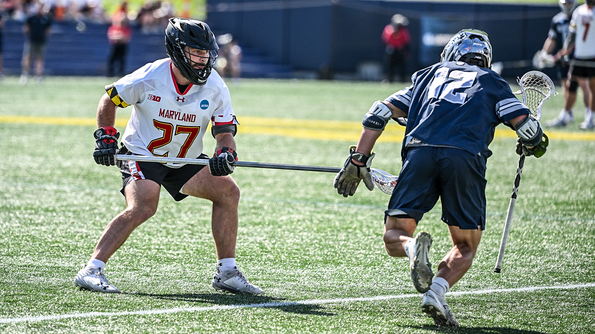 Maryland defenseman Will Schaller defends Georgetown attackman Aidan Carroll in an NCAA men's lacrosse quarterfinal game at Navy-Marine Corps Memorial Stadium in Annapolis, Md.