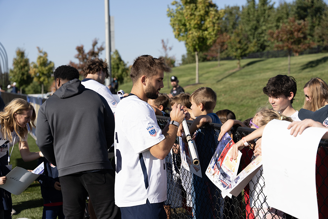 Grant Ament signs an autograph after a USA game
