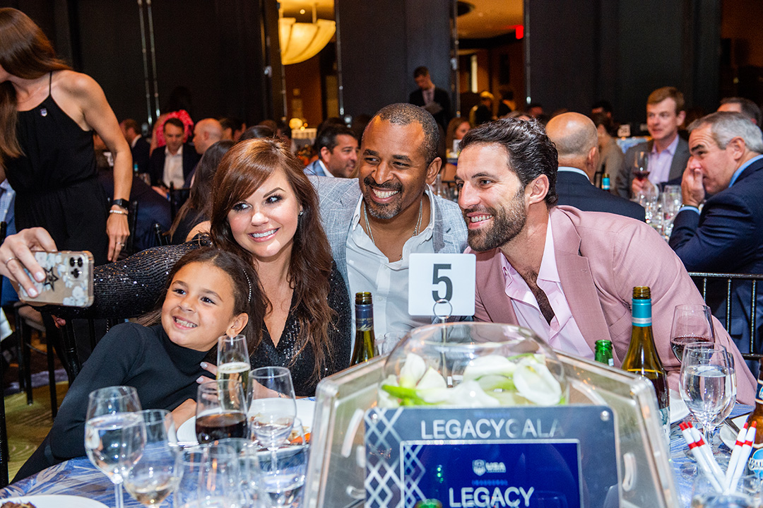 Kyle Harrison and Paul Rabil pose for a selfie with Harrison's wife and daughter