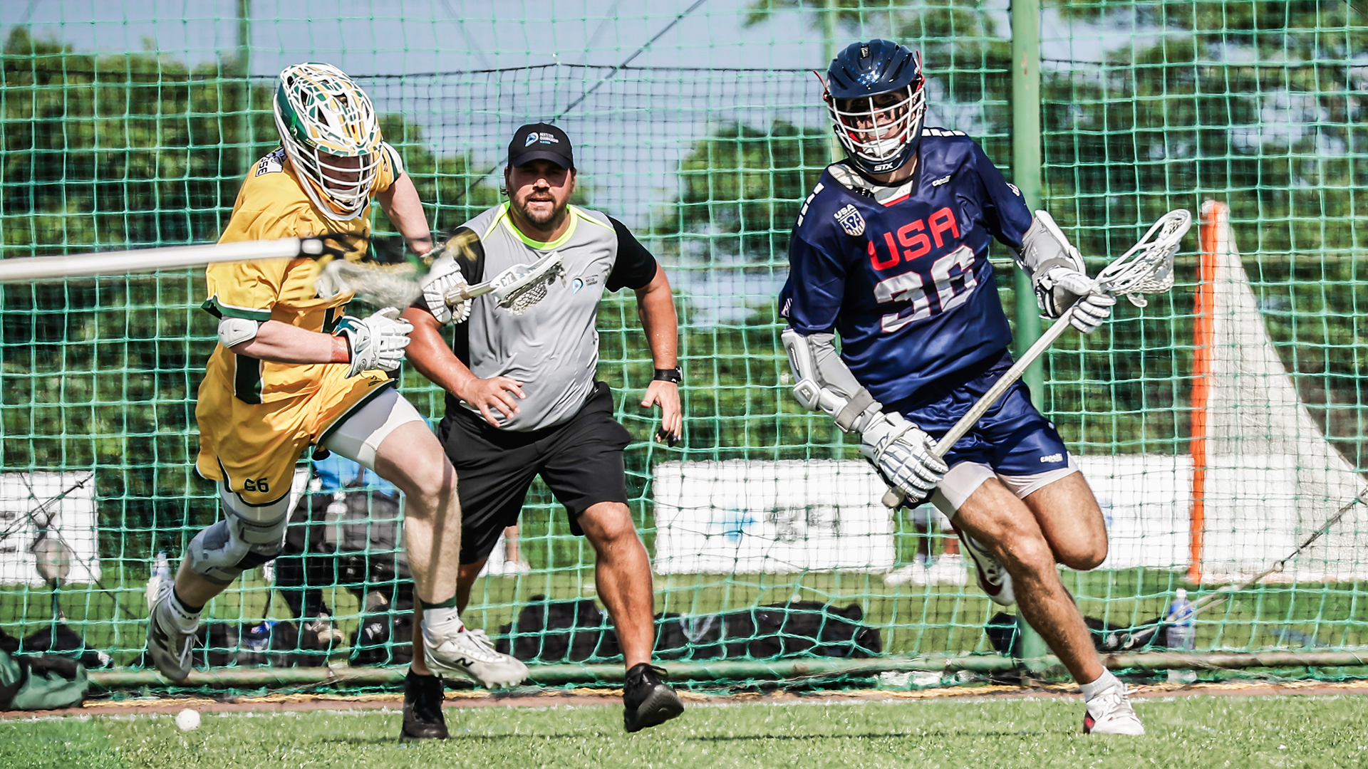 USA U20 lacrosse player Jack Speidell with ball in stick as Australia defenseman pursues him at World Lacrosse Men's U20 Championship in South Korea.