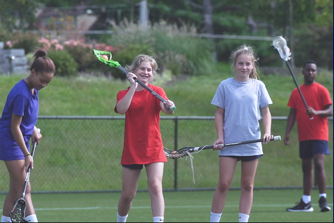 Picture of young lacrosse players learning how to pass the ball