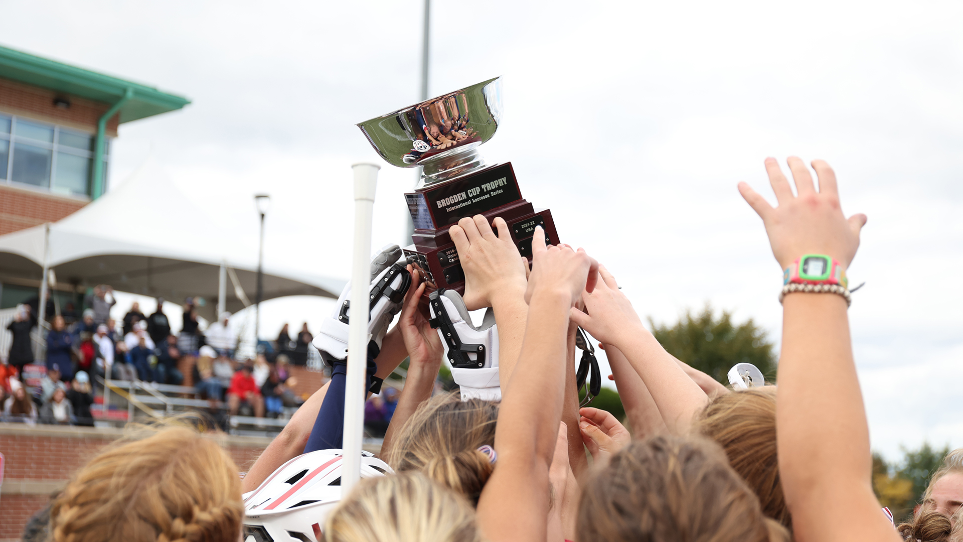 Players hold the Brogden Cup in the air