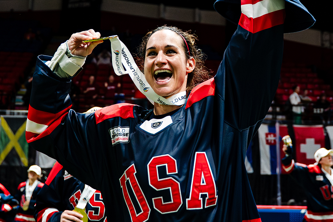 Kristen Carr holds up gold medal after winning box lacrosse world championship