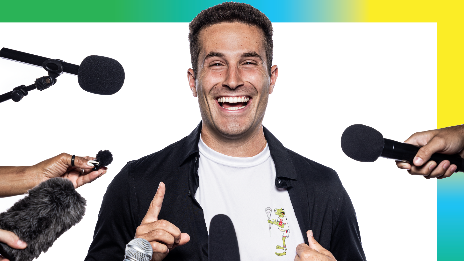 Mitchell Pehlke smiling at a podium with microphones and hands in his face during a USA Lacrosse Magazine photo shoot in Sparks, Md.