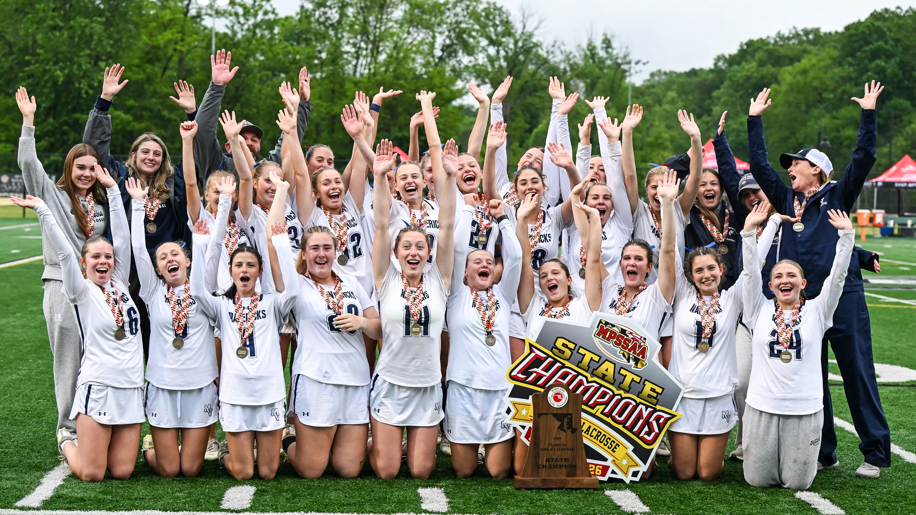 Manchester Valley (Md.) girls' lacrosse team celebrates its 2026 state championship with banner and trophy