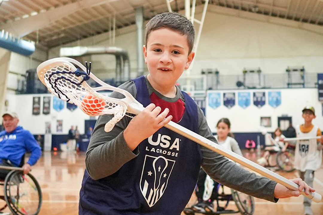 Young boy at a USA Lacrosse clinic
