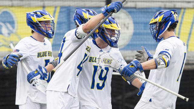Delaware men's lacrosse players congratulate Mike Robinson (#19) after a goal.