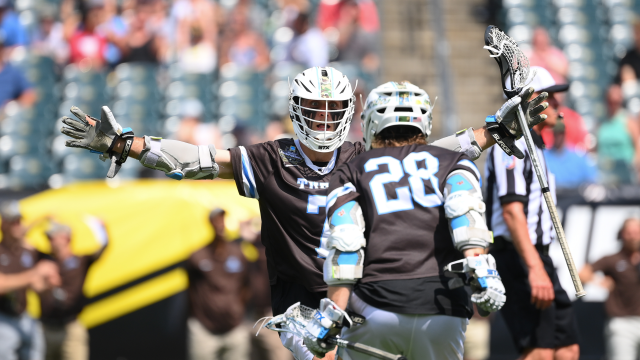 Tufts lacrosse players celebrate at the end of their NCAA championship game win over RIT.