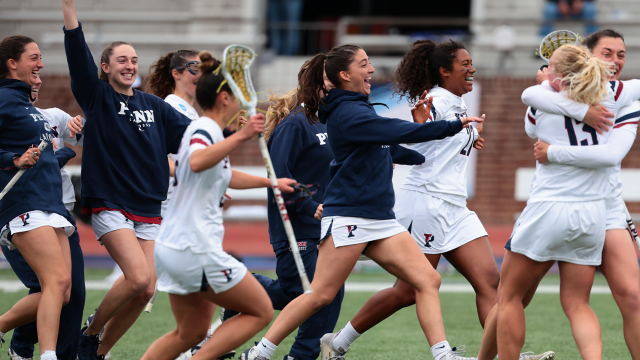 Penn storms the field to celebrate its win over Loyola.