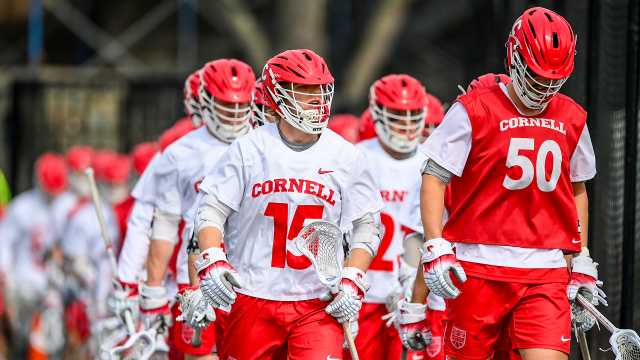 CJ Kirst leads the Cornell men's lacrosse team onto Schoellkopf Field before a game against Princeton.