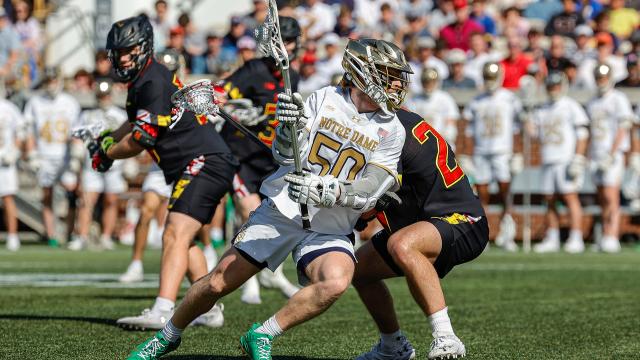 Notre Dame's Chris Kavanagh cradles the ball as he moves around a Maryland defender.