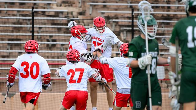 C.J. Kirst jumps in the air and celebrates with teammates after setting the NCAA career goals record