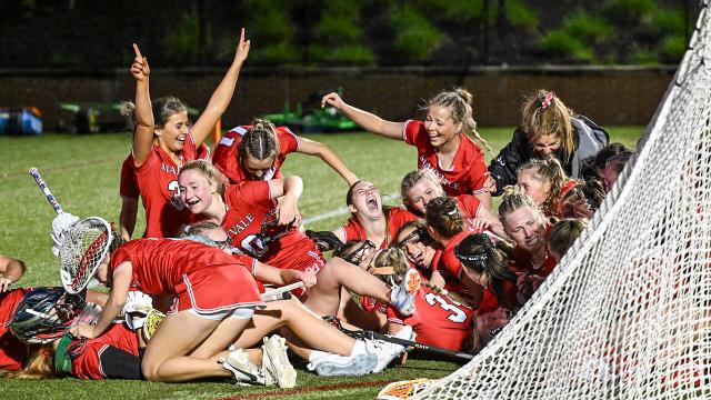 Maryvale (Md.) girls' lacrosse players pile onto each other behind the goal after clinching the school's first IAAM A title since 2002 at USA Lacrosse's Tierney Field in Sparks, Md.