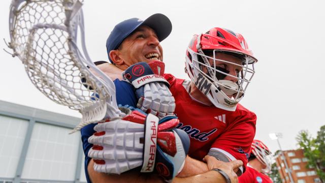 A Richmond men's lacrosse player embraces coach Dan Chemotti as the Spiders celebrate an NCAA tournament  first-round win at North Carolina.