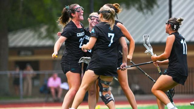 Coastal Carolina women's lacrosse players celebrate a goal