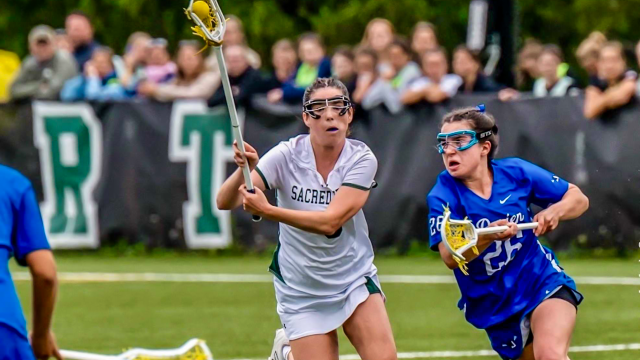 Sacred Heart Greenwich (Conn.) girls' lacrosse player Charley Bacigalupo under pressure by a Darien (Conn.) defender