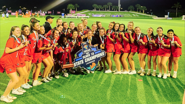Lake Highland girls' lacrosse with FHSAA championship banner
