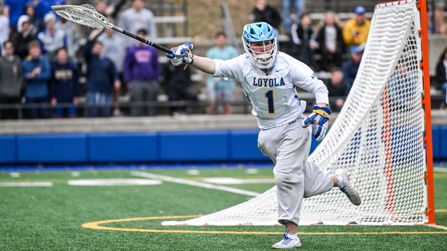 Loyola Blakefield (Md.) boys' lacrosse goalie running toward end line with stick outstretched