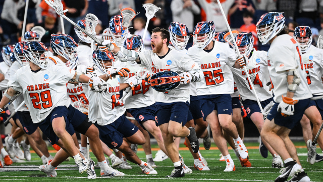 Owen Hiltz sprints to celebrate in front of his Syracuse lacrosse teammates after scoring to give the Orange a 13-12 overtime victory over Harvard at the JMA Wireless Dome.