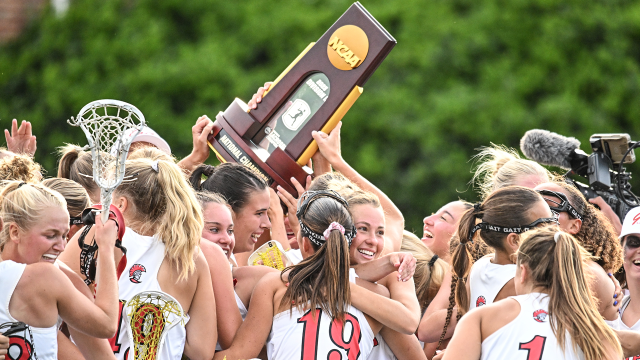 Tampa women's lacrosse players celebrate with the NCAA championship trophy in their possession at Kerr Stadium in Salem, Va.