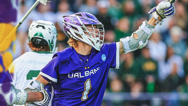 UAlbany men's lacrosse player Ryan Doherty signals to the crowd after scoring.