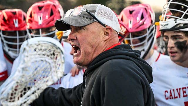 Calvert Hall (Md.) boys' lacrosse coach Bryan Kelly in the huddle during a 2025 MIAA game against McDonogh (Md.)