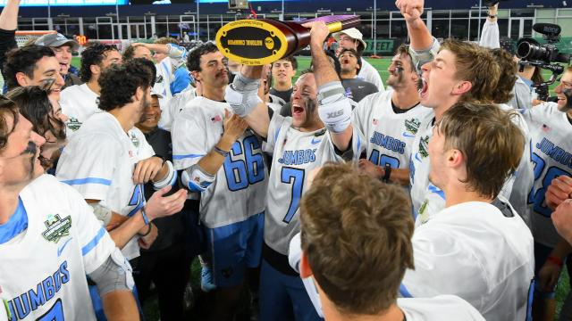 Tufts men's lacrosse hoists the national championship trophy