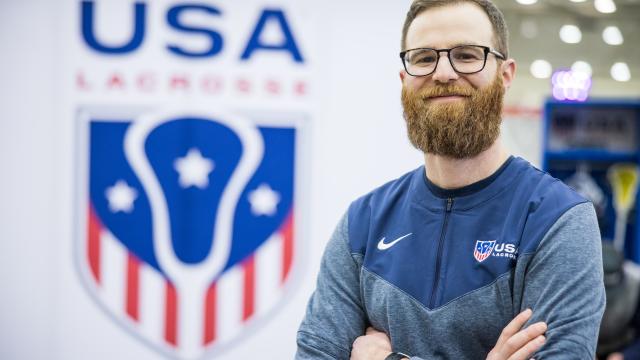 article subject standing with arms crossed and smiling