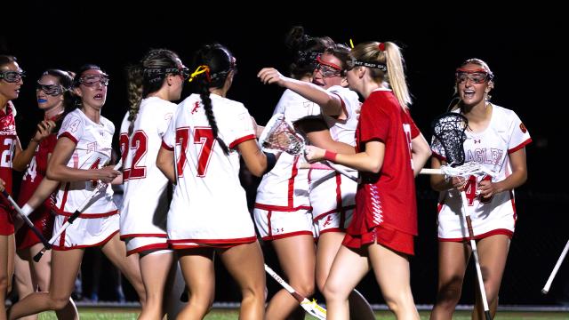 Flagler women's lacrosse celebrates a goal against Florida Southern