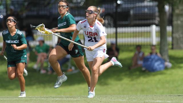 Katie Goodale runs with the ball while two Mexican defenders chase her during the Pan American championship.
