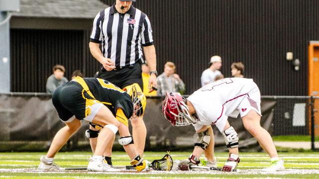 Loomis Chaffee (Conn.) faceoff specialist Hayden Goozh crouches for a faceoff against Brunswick (Conn.)