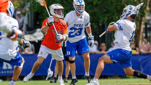 Virginia's Joey Terenzi looks at the goal in close surrounded by Duke players.
