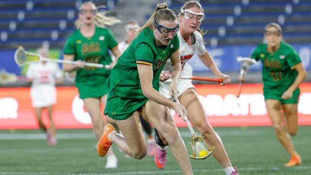 A Notre Dame player fights for a ground ball